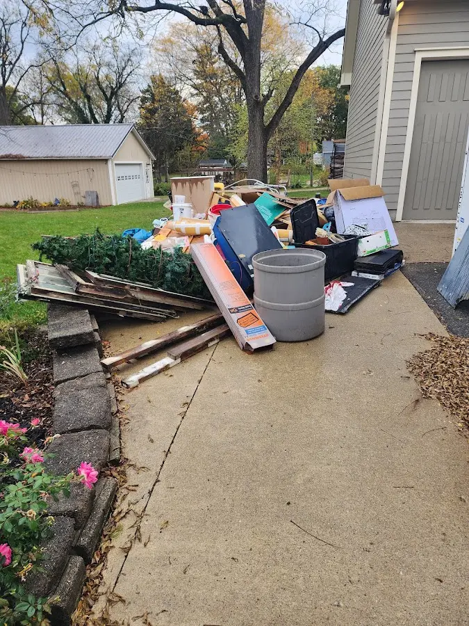 Dumpster being loaded with debris for Roofing Dumpster Rental in Kalaheo